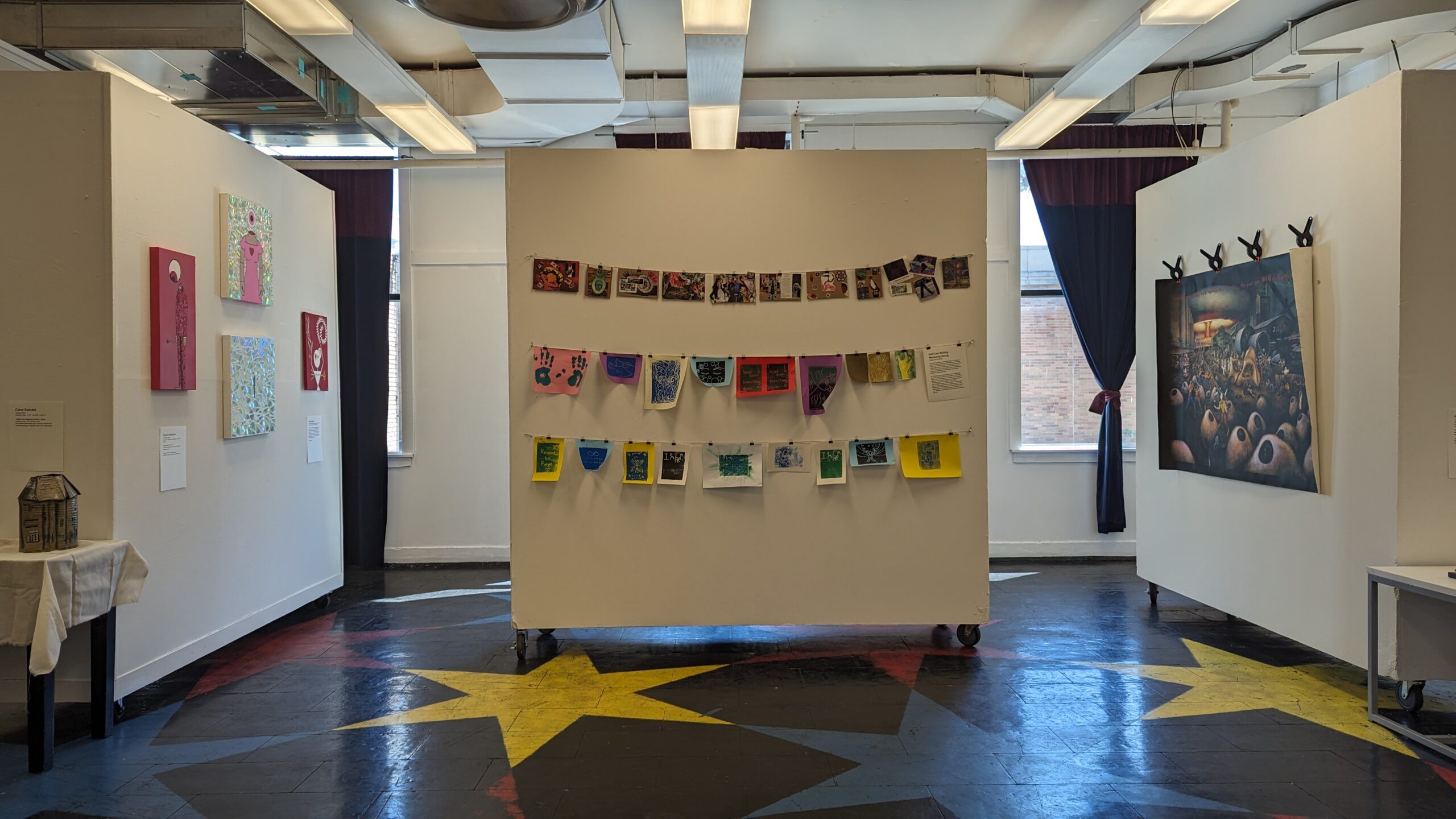 Documentation from Coming Home, a 2024 public art exhibition and poetry reading curated by Meadow Jones at the Urbana-Champaign Independent Media Center.